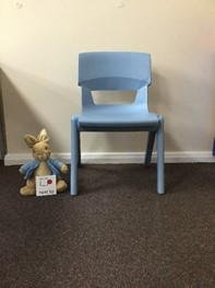 Teddy next to the chair
